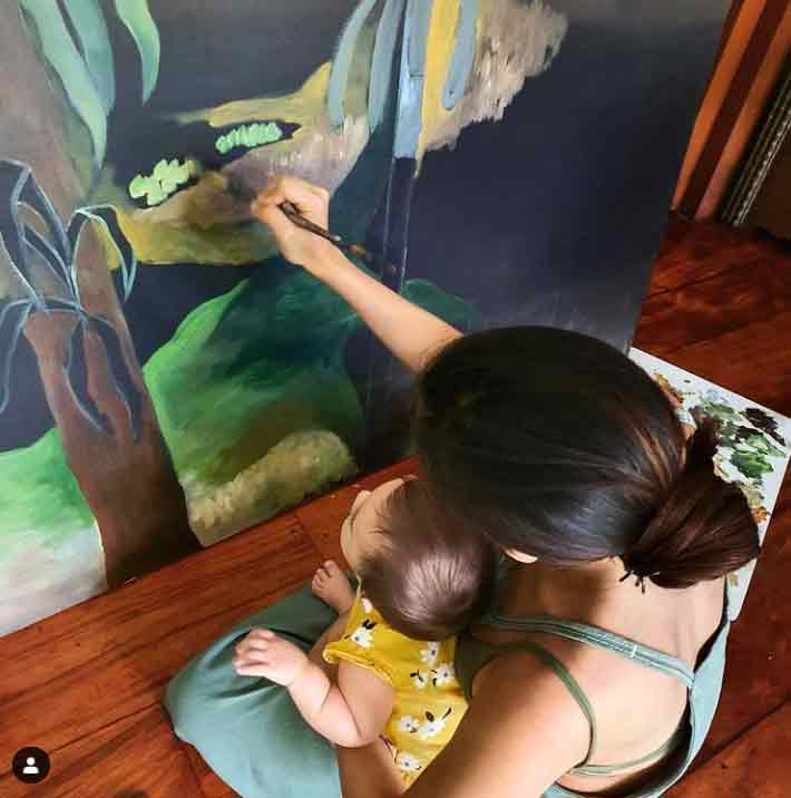 Baby Tili watches Mom Solenn while painting