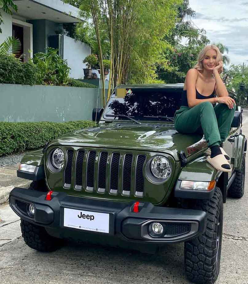 Sarah Lahbati sitting on Jeep Wrangler Rubicon