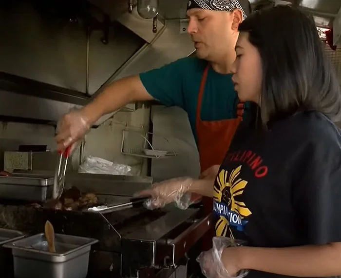 Lorry Martinez and Adan Garcia cooking in their food truck