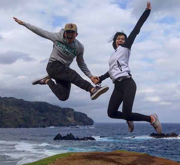 couple jumping hill batanes