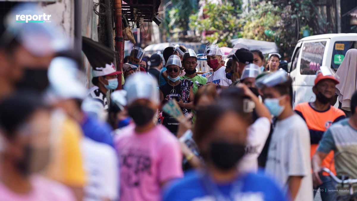 Crowded area, people wearing face shields