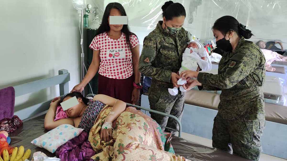 Members of the Philippine Army taking care of former rebel's baby