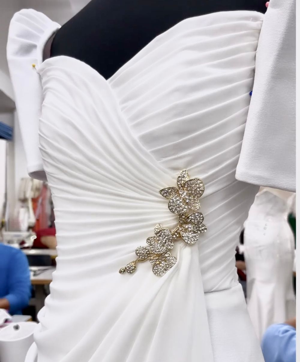 Mark Bumgarner adds a custom sampaguita brooch as the complementary piece of Toni's inaugural gown.