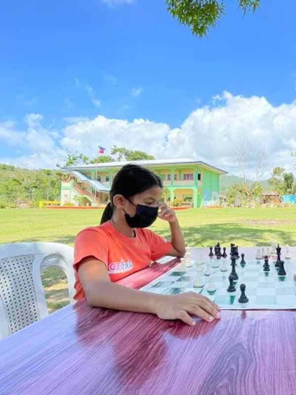 Stephanie Jabagat in front of a chess board