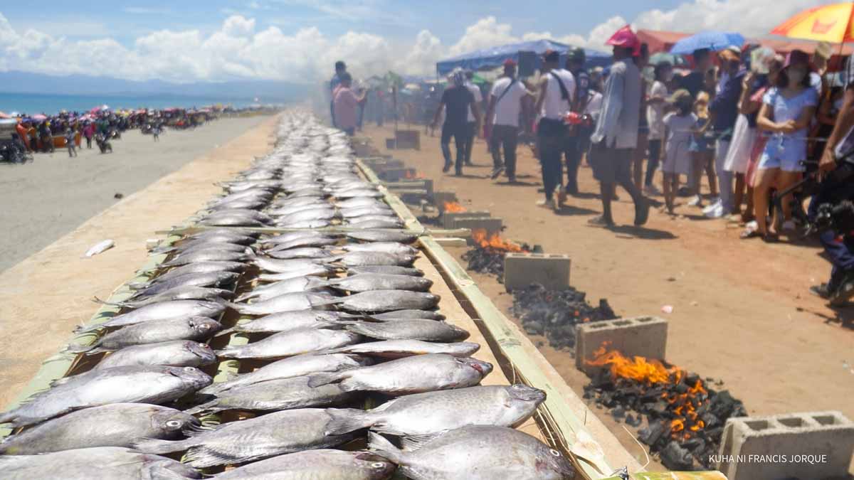 Buguey residents participating in grilling malaga fishes