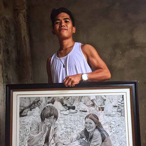 Niño Jasper Conje Gomez with one of his paintings