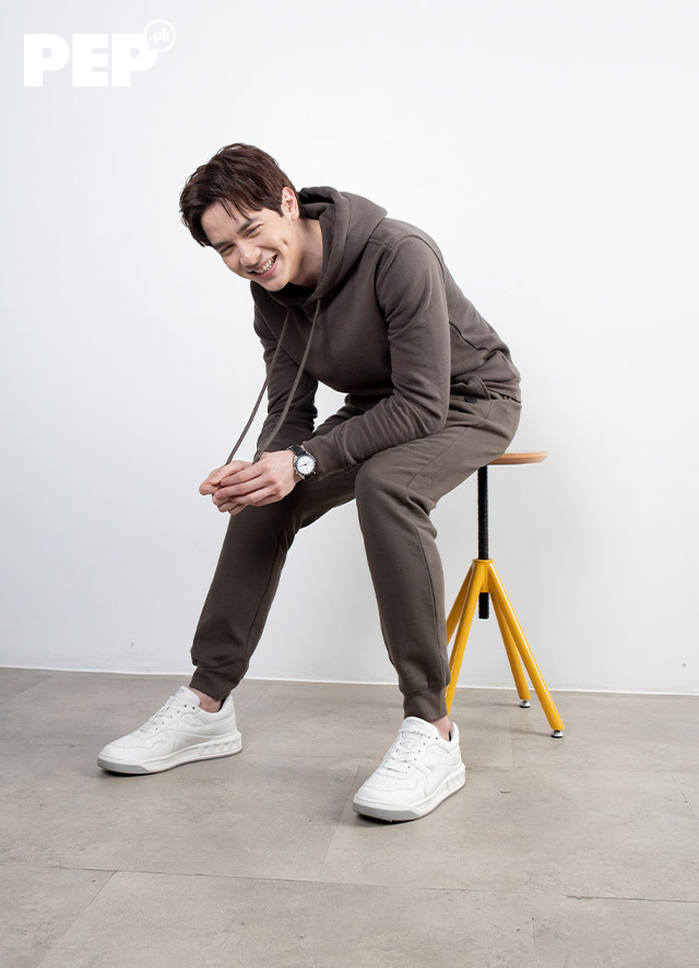 Alden Richards is wearing a 7 For All Mankind hoodie and sweatpants coordinates, and Valentino sneakers.