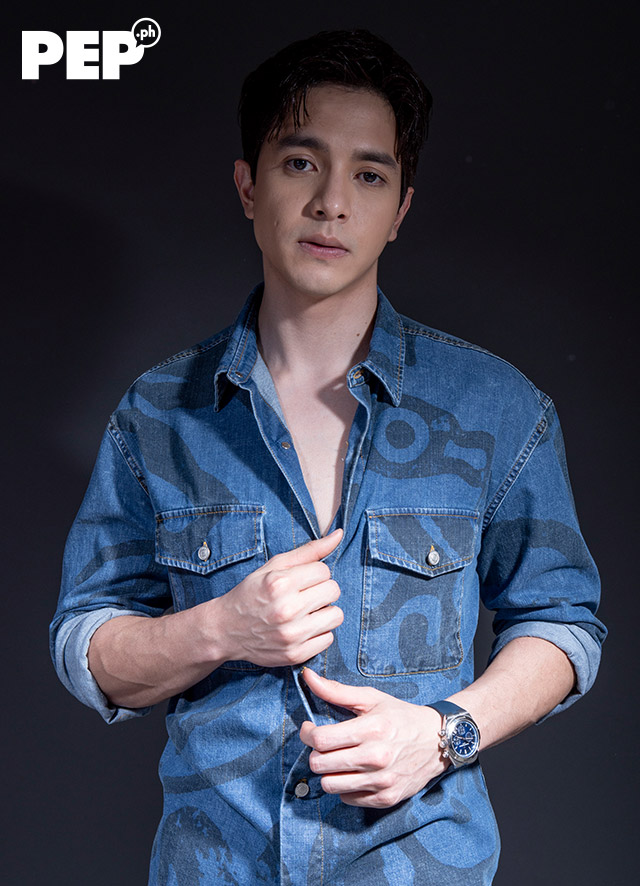 Alden Richards is wearing a KENZO denim top from Cul-De-Sac, 7 For All Mankind jeans, and Valentino sneakers.