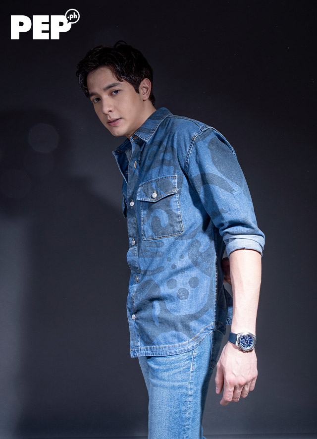 Alden Richards is wearing a KENZO denim top from Cul-De-Sac, 7 For All Mankind jeans, and Valentino sneakers.