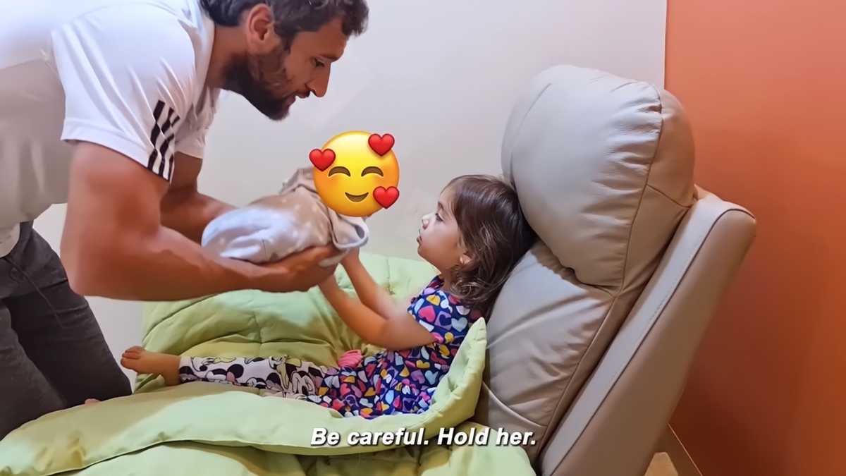Nico Bolzico lets Tili hold her baby sister