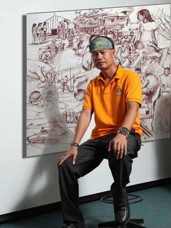 Elito Circa with one of his paintings