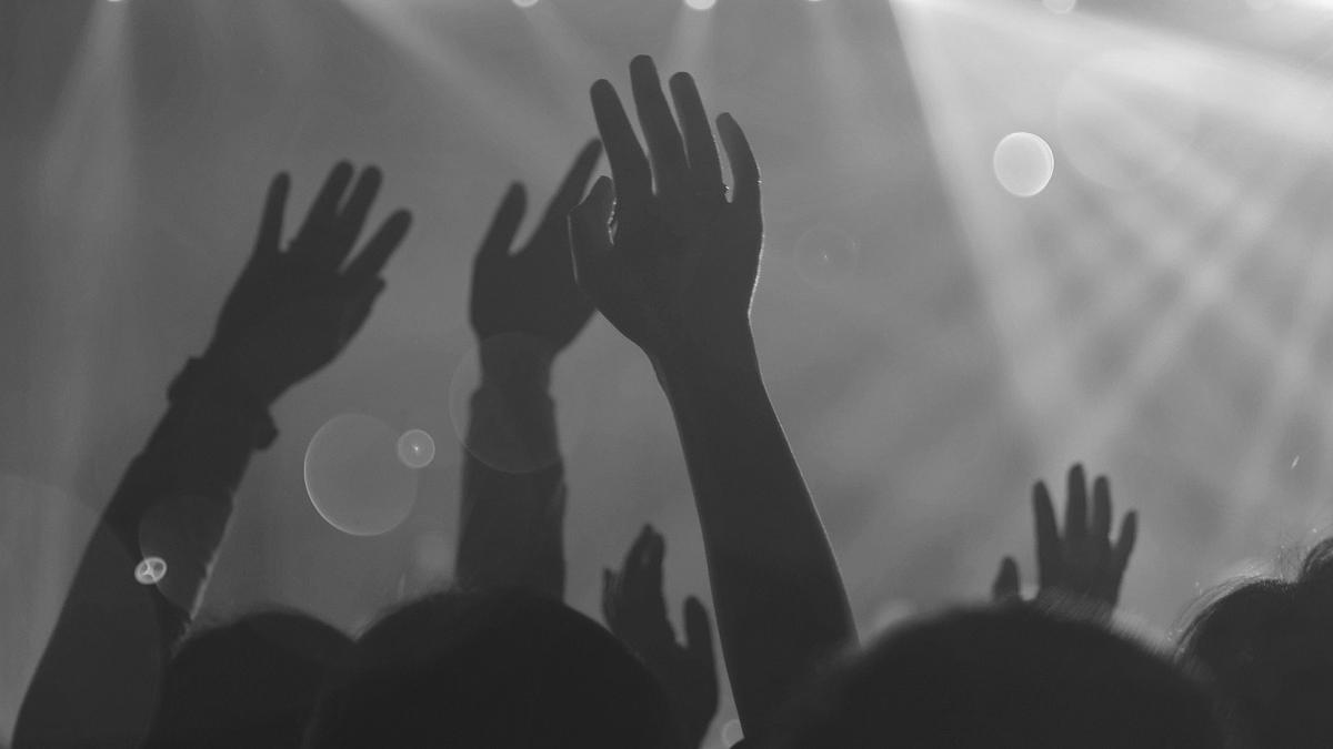 hands raised at a concert 